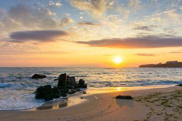 sunrise at the beach with gorgeous sky. summer getaway wallpaper on a black sea. vacation season. calm water and orange clouds. bulgaria travel background. sunny holiday seascape. sun above horizon