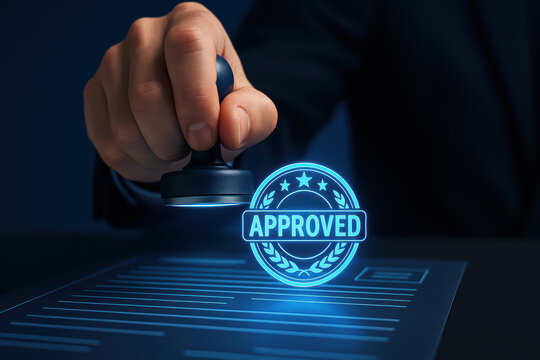 Hand holding stamp applies approval mark on document, showcasing holographic effect. This conveys sense of validation and professionalism