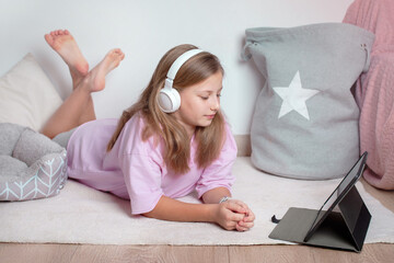 Happy girl with tablet on fluffy carpet