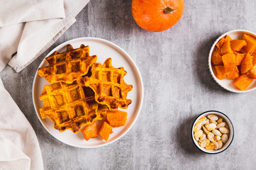 Sweet baked pumpkin waffles on a plate on the table top view