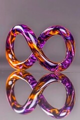 Vibrant glass infinity loop sculpture with purple and orange swirls on reflective surface