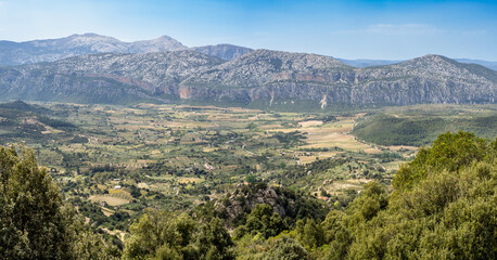 Fototapeta premium View of fields and mountains from Suttaterra arch in Sardinia island