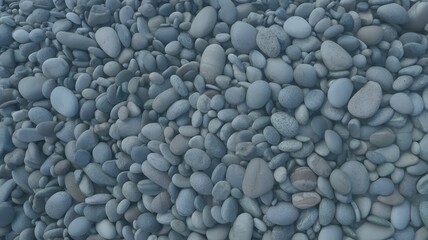 A dense collection of smooth gray stones filling the entire frame