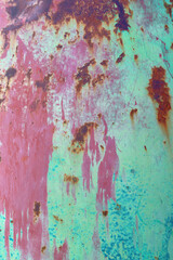 Heavily rusted metal surface with worn blue paint remnants.