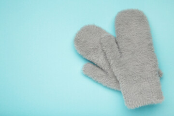 Winter mittens on blue background, warm mittens