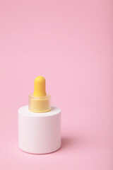 Minimalist white cosmetic dropper bottle on pink background. Elegant mockup for skincare, serum, or beauty branding presentations.