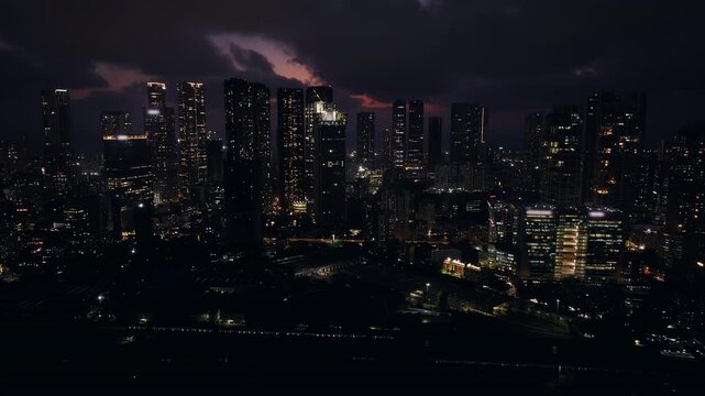 Cinematic aerial view of Mumbai's downtown night scene. Central Mumbai's cityscape and skyline- Lalbaug-Parel, Worli, Prabhadevi. beautiful modern buildings, bright glowing lights, and roads.
