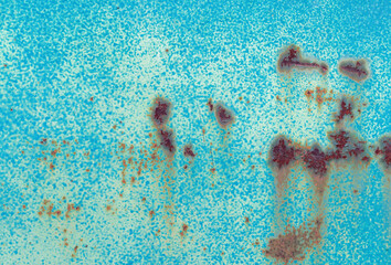 Rust and peeling turquoise paint on old metal surface.