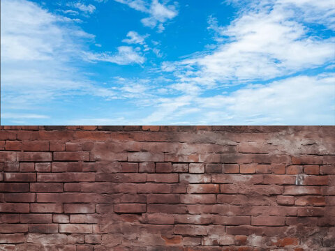Old red brick wall against blue sky