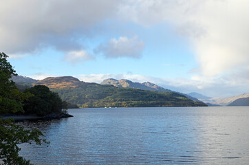 Evening view north up the loch past Cruach Tairbeirt to Ben Vorlich from Firkin Point, a viewpoint off the A82 on the west shore of Loch Lomond, OS map ref NN 338 007, Argyll and Bute, Scotland.