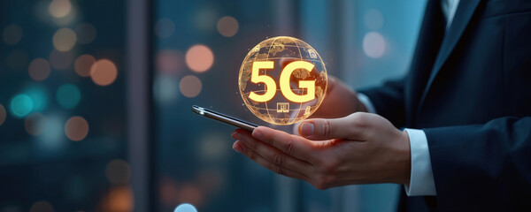 Man holds smartphone displaying glowing 5G globe with icons. Business man uses mobile device for modern wireless connection. Future tech concept.