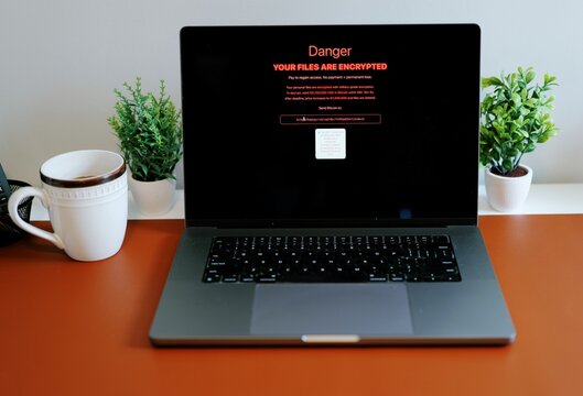 Middle Aged Executive Man Working From Home Falls Victim to Spear Phishing Ransomware Attack - Common Cybersecurity Scenario Concept