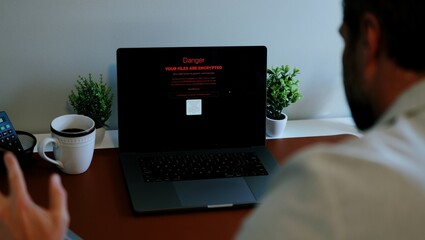 Middle Aged Executive Man Working From Home Falls Victim to Spear Phishing Ransomware Attack - Common Cybersecurity Scenario Concept