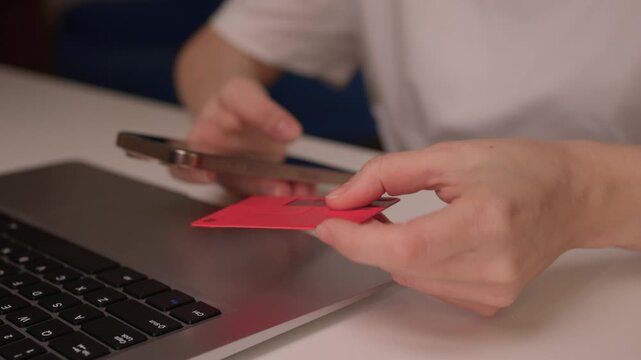 Hidden transaction amid dim lighting, Suspicious handoff between devices under low light, Scene depicting covert credit card transfer warning about online fraud risks