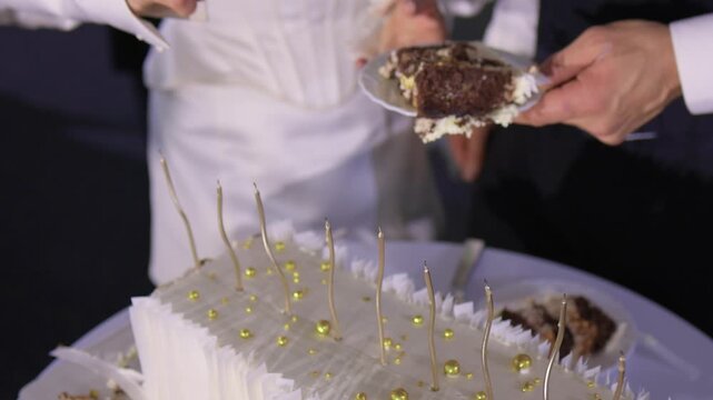 Couple shares wedding cake, Bride and groom enjoy their special cake moment together, Bride and groom cheerfully cut their elegant wedding cake amid joy and celebration