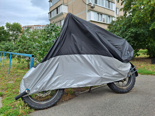 Cover on a motorcycle parked near house © Harmony Video Pro