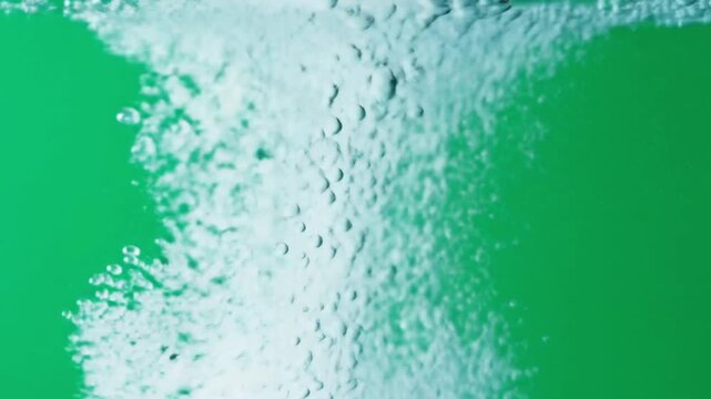 Refreshing bubbly water rising against vibrant green background for a clean, crisp feel with dynamic movement and energy, great for health ads