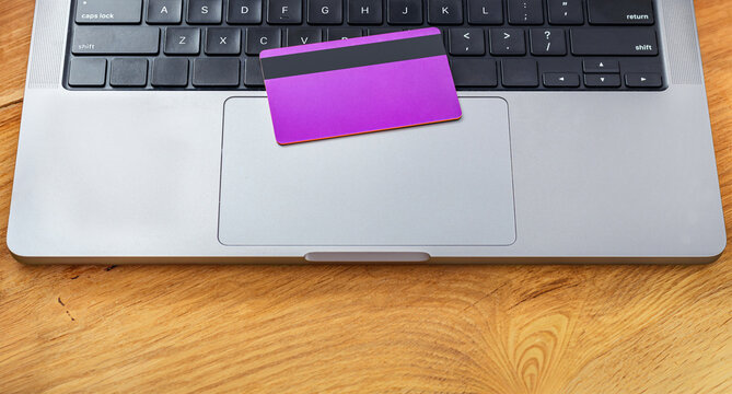 Closeup credit card on laptop for payments - Powered by Adobe