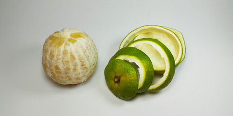 Green Spiral Citrus Peel on White Background &mdash; Minimalist Organic Fresh Fruit Concept