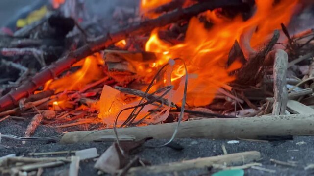 Intense Flames Engulfing Wood and Debris in a Bonfire.