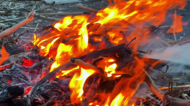 Intense Flames Engulfing Wood and Debris in a Fiery Inferno.