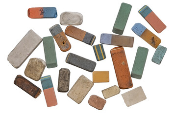 A collection of various used and worn-out erasers, flat lay photograph of a scattered collection of vintage, heavily used, and well-worn rectangular erasers