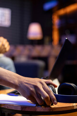 African american freelancer participates at a web class course on laptop, engaging in a discussion to improve his skills. Male person enjoying a webinar lesson from home, chatting.