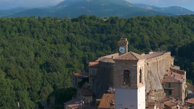 Italian hilltop town sorano aerial view. Aerial panoramic tilting shot revealing the medieval village of sorano, a historic town perched on a tuff rock, surrounded by lush green forests