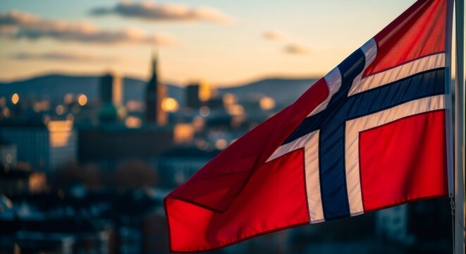 Waving Norway flag over a city skyline at sunset. National symbol of patriotic pride and independence Day celebration.