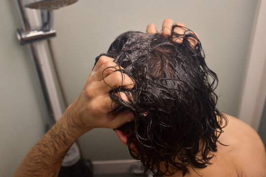 Personal hygiene routine, Cleaning and relaxing shower time, Individual cleansing session in steamy bathroom, Relaxing personal grooming amidst humid shower environment