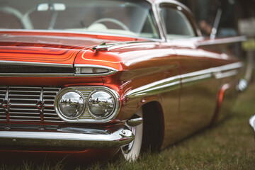 Naklejka premium Classic custom car with chrome details and a vibrant orange paint job