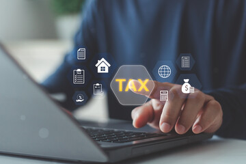 Concept of digital taxation, e-filing and financial management technology. Businessman using digital interface to manage online tax payment, financial data and accounting information on laptop.
