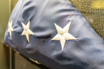 Naklejka premium Indoor image of a slightly tilted, soft-focused American flag with blue background and white stars Stripe pattern is present but not clear due to angle and quality No visible texts or human figures