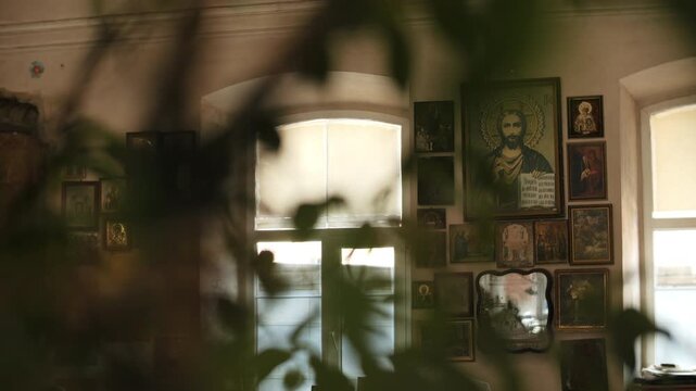 Room interior with religious icons on wall and natural light from window