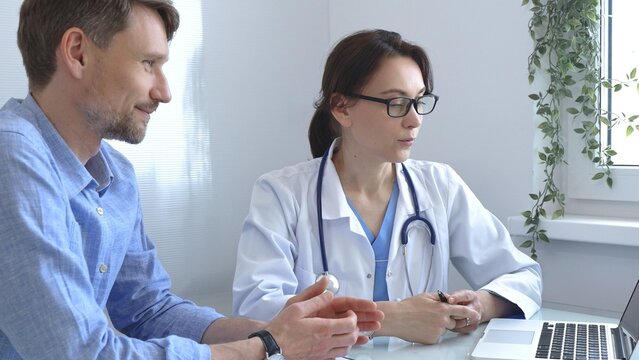 Female doctor explaining a diagnosis to a male patient, offering medical advice and support during a consultation in her office, fostering communication and trust. Medicine and health care