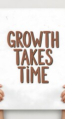 Inspirational quote displayed on a white wall with decorative 3D lettering that reads 'Growth Takes Time' in a modern and motivational setting