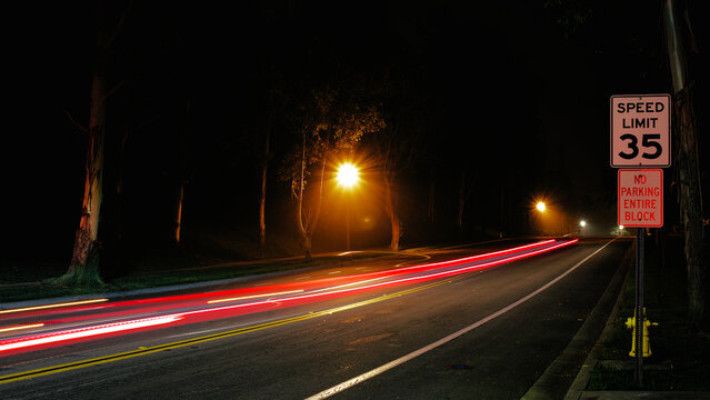 Night Street Light Trails Under Speed Limit Sign – Urban Long Exposure Photography