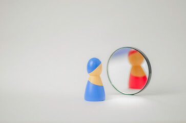 Person icon seeing different reflection in mirror