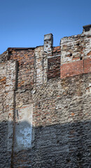 Abandoned, dilapidated apartment building. Old, worn brick walls.