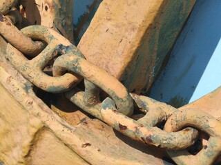 Rusty Heavy Metal Chain on Corroded Industrial Surface