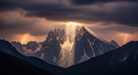 Dramatic mountain landscape illuminated by sunlight breaking through storm clouds