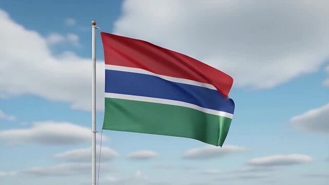 Proud Gambian flag waving dynamically against a bright blue sky with fluffy white clouds