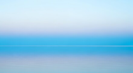 Calm ocean view with soft blue hues and a clear horizon line at dusk