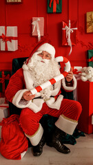 Santa Claus holding a candy cane in a festive Christmas setting