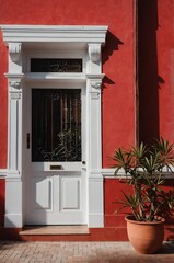 Fototapeta premium Portrait of white door on red wall background, beautiful architecture aesthetic concept