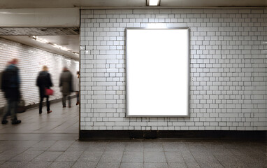 Blank advertising billboard in a busy subway station hallway with blurred commuters walking past, perfect for impactful campaigns.