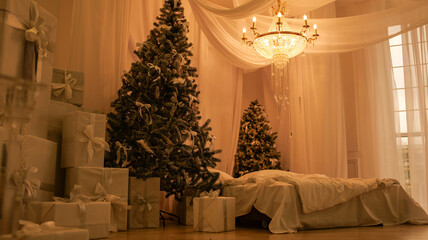 Christmas bedroom with decorated tree, gifts, and elegant chandelier
