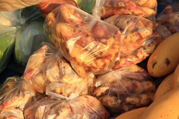 Fototapeta premium Many bags of sweet potatoes waiting to be sold in the market.