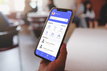 A person using a health application on a smartphone to search for a doctor, book an appointment,...