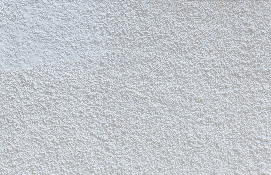 Beautiful view of popcorn sprayed ceiling of street wall of white building.